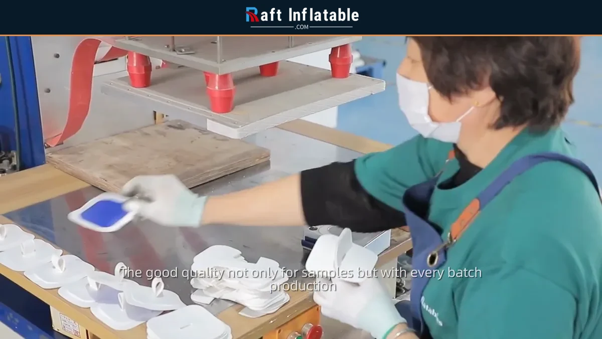 Worker operating a production press for inflatable boat components